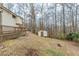 Exterior side view of backyard leads to a small outdoor storage building at 3998 Chimney Ridge Dr, Ellenwood, GA 30294