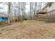 Wide shot of the backyard with the house and deck on one side at 3998 Chimney Ridge Dr, Ellenwood, GA 30294