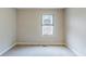 A carpeted bedroom with a window providing natural light at 3998 Chimney Ridge Dr, Ellenwood, GA 30294