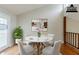 Dining room showcases a contemporary table with seating, modern art, and bright doors to outside space at 3998 Chimney Ridge Dr, Ellenwood, GA 30294