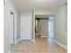Hallway with neutral paint and tile floor leading to different parts of the house at 3998 Chimney Ridge Dr, Ellenwood, GA 30294