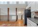 Open kitchen features stainless steel refrigerator, white cabinets, and adjacent dining area at 3998 Chimney Ridge Dr, Ellenwood, GA 30294