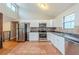 Bright kitchen with stainless steel appliances, white cabinets, and tile flooring at 3998 Chimney Ridge Dr, Ellenwood, GA 30294