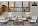 Virtually staged living room with neutral paint and carpet and views to the staircase and upstairs at 3998 Chimney Ridge Dr, Ellenwood, GA 30294