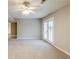 Spacious basement living room with carpet flooring and a pair of french doors leading outdoors at 3998 Chimney Ridge Dr, Ellenwood, GA 30294