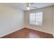 A bedroom with a window for natural light and featuring wood laminate flooring and a ceiling fan at 1553 Nicole Ridge Ct, Loganville, GA 30052