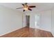 Bright bedroom boasts hardwood floors, a ceiling fan, and access to a private bathroom at 1553 Nicole Ridge Ct, Loganville, GA 30052
