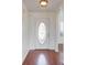 Foyer area with a decorative glass door and hardwood floors at 1553 Nicole Ridge Ct, Loganville, GA 30052