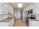 Galley kitchen featuring stainless steel appliances, ample cabinet space, and neutral countertops at 1553 Nicole Ridge Ct, Loganville, GA 30052
