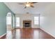 Cozy living room featuring a stone fireplace and hardwood floors at 1553 Nicole Ridge Ct, Loganville, GA 30052