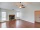 Bright living room with a stone fireplace, fan, and access to the backyard at 1553 Nicole Ridge Ct, Loganville, GA 30052