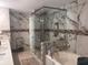 Elegant bathroom with marble tile, glass enclosed shower, and soaking tub at 2610 Gadsen Walk, Duluth, GA 30097
