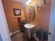 Charming powder room with pedestal sink and decorative mirror at 2610 Gadsen Walk, Duluth, GA 30097