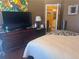 Bedroom with hardwood flooring, large dresser and doorway access to the bathroom at 2610 Gadsen Walk, Duluth, GA 30097