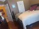 Bedroom with hardwood flooring, a soft bed, and two doorways at 2610 Gadsen Walk, Duluth, GA 30097