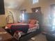 Well-lit bedroom featuring a king-size bed, a hanging chair, and tasteful window dressings at 2610 Gadsen Walk, Duluth, GA 30097