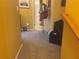 Carpeted hallway with natural light and bright, golden yellow painted walls at 2610 Gadsen Walk, Duluth, GA 30097