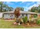 Charming single-story home featuring lush landscaping, a well-manicured lawn, and inviting curb appeal with flower beds at 5346 Lee Cir, Forest Park, GA 30297