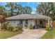 Inviting single-story house featuring a covered carport, landscaped yard, and a charming exterior at 5346 Lee Cir, Forest Park, GA 30297