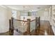 Upstairs landing featuring hardwood floors and custom built-in shelving at 8265 Majors Glen Ct, Cumming, GA 30041