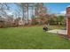 Well maintained backyard with mature trees, lush green grass, and outdoor seating area at 3207 Haleys Way, Conyers, GA 30013