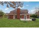 A large backyard features a well-manicured lawn, patio area, and brick exterior at 3207 Haleys Way, Conyers, GA 30013