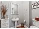 Cozy half bathroom with a pedestal sink and wall decor at 3207 Haleys Way, Conyers, GA 30013