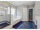 Large bathroom features a soaking tub, glass shower and walk-in closet at 3207 Haleys Way, Conyers, GA 30013