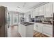 Bright kitchen with white cabinets, dark countertops, stainless appliances, and breakfast nook area at 3207 Haleys Way, Conyers, GA 30013