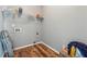 Empty laundry room with wood-look flooring, wire shelving, and hookups ready for your appliances at 3207 Haleys Way, Conyers, GA 30013