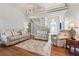 Bright living room with hardwood floors, modern furnishings, and a staircase leading to the upper level at 3207 Haleys Way, Conyers, GA 30013