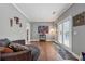 Cozy sitting room with a plush sofa, artwork, and a door leading to an outdoor space at 3207 Haleys Way, Conyers, GA 30013
