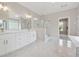 Bathroom featuring double vanities, marble floors, a large shower with glass enclosure, and modern lighting at 8023 White Stone Blvd, Douglasville, GA 30135