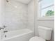 Bathroom with tub shower featuring white subway tile at 8023 White Stone Blvd, Douglasville, GA 30135