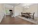 Open floor plan from dining room to living room with staircase and hardwood floors at 8023 White Stone Blvd, Douglasville, GA 30135