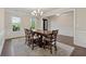 Dining area with a wooden table set on a patterned rug and lots of natural light at 8023 White Stone Blvd, Douglasville, GA 30135