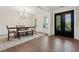Formal dining room featuring hardwood floors, decorative molding, and a stylish light fixture at 8023 White Stone Blvd, Douglasville, GA 30135