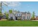 Beautiful brick-and-siding two-story home with a well-manicured lawn and mature trees at 8023 White Stone Blvd, Douglasville, GA 30135