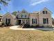 Charming two-story home featuring a brick facade, gray accents, a well-maintained lawn and a welcoming entrance at 8023 White Stone Blvd, Douglasville, GA 30135