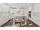 Beautiful kitchen with white cabinets, stainless appliances, hardwood floors and an island with a bar at 8023 White Stone Blvd, Douglasville, GA 30135