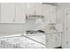 Modern kitchen featuring sleek white cabinets, stainless steel appliances, and stylish countertops at 8023 White Stone Blvd, Douglasville, GA 30135
