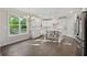 Bright kitchen with white cabinets, stainless appliances, hardwood floors, and a large window with a backyard view at 8023 White Stone Blvd, Douglasville, GA 30135