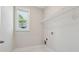 Bright laundry room with window and shelving at 8023 White Stone Blvd, Douglasville, GA 30135