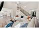 Spacious living room with a view of the kitchen, staircase, and front door; hardwood floors throughout at 8023 White Stone Blvd, Douglasville, GA 30135