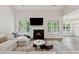 Bright living room with fireplace, large windows, hardwood floors and a vaulted ceiling at 8023 White Stone Blvd, Douglasville, GA 30135