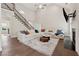 Open-concept living room with a fireplace, hardwood floors, and a staircase leading to the second floor at 8023 White Stone Blvd, Douglasville, GA 30135