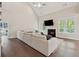 Bright living room with vaulted ceilings, a fireplace, hardwood floors, and large windows at 8023 White Stone Blvd, Douglasville, GA 30135