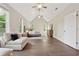 Bright main bedroom featuring a vaulted ceiling, hardwood floors, and comfortable seating area at 8023 White Stone Blvd, Douglasville, GA 30135