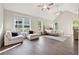 Spacious main bedroom with vaulted ceiling, hardwood floors, sitting area, and bright natural light at 8023 White Stone Blvd, Douglasville, GA 30135