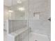 Modern bathroom shower with marble tile and built-in seat at 8023 White Stone Blvd, Douglasville, GA 30135